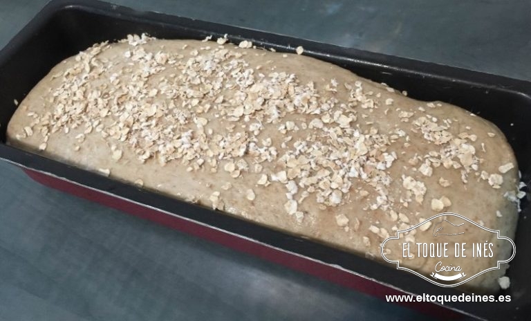 Una vez el pan esté listo pintamos la superficie con un poco de agua y espolvoreamos los copos de avena para que queden pegados.