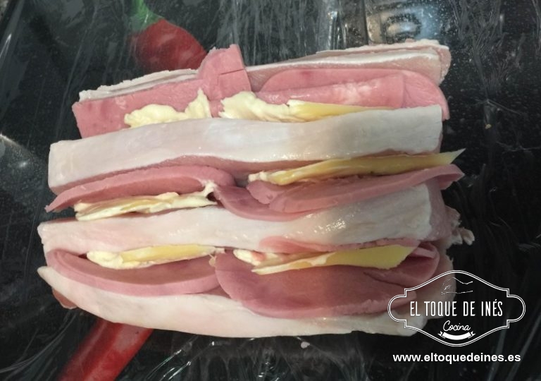 Hacemos unos cortes en el lomo, pero no como se corta normalmente sino perpendicular, no llegamos hasta el fondo.
Colocamos el jamón york o serrano y el queso en las ranuras.