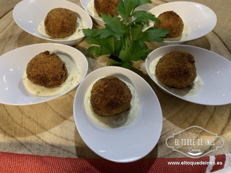 En unas cucharitas o como más os guste colocamos una cucharadita de salsa tártara y encima la bolita de salmón.